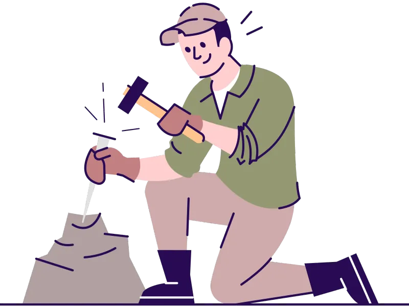 A man chizzling some rock